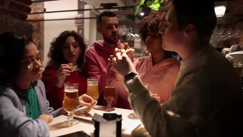 Group of friends enjoying a dinner with wine in a restaurant.