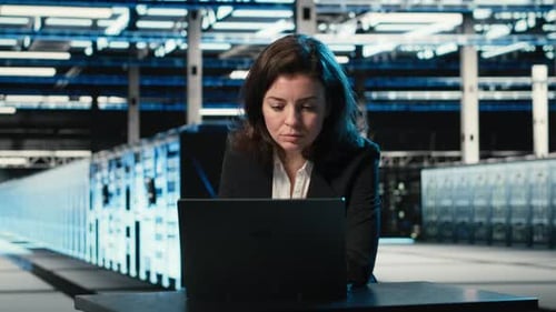 Typing on Keyboard Laptop and Engineer in Data Center