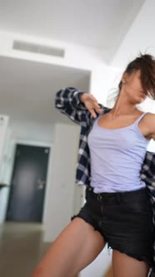 Young Woman Dancing Energetically Indoors
