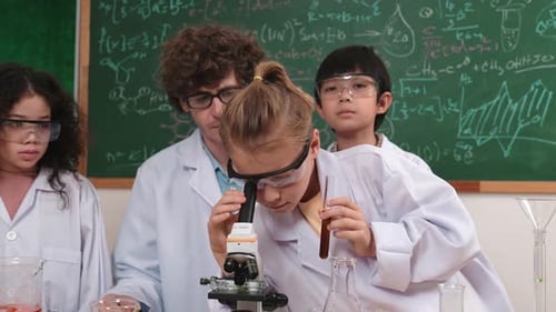 Kids Doing Science Experiments in Classroom with Teacher