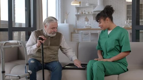 Woman Helps Senior Man Sort Game Pieces