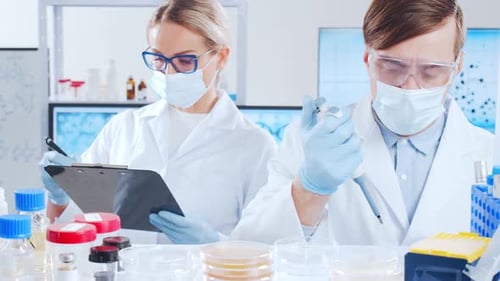 Scientists Working in Bright Medical Research Laboratory