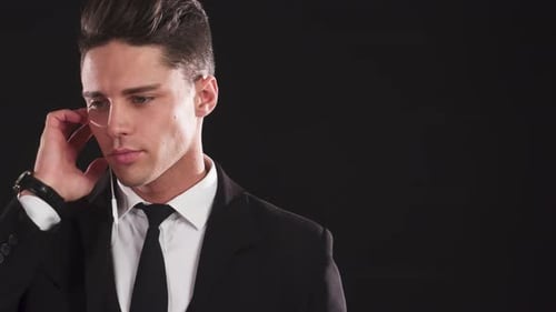 Young Man in Suit with Earpiece Looking Professional