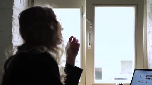 Young Woman Working on Her Laptop Computer in Coffee Shop