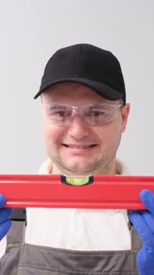 Man with Water Building Level Construction Tool Equipment Repair Vertical Video