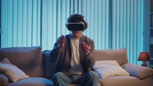 Young Man Using Virtual Reality Headset on Couch