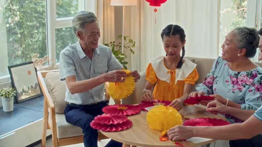 Cover for Cheerful Family Members Making Decorations for Lunar New Year
