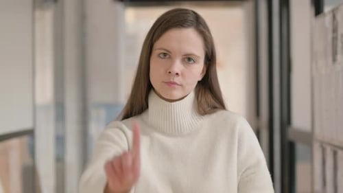 Woman Says No with Finger in Office Setting