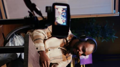 Man Talking Into Microphone and Recording