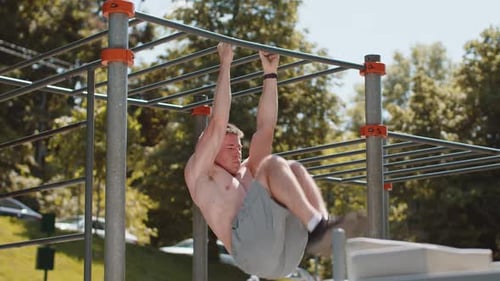 Athletic Man Doing Abdominal Exercises Outdoors
