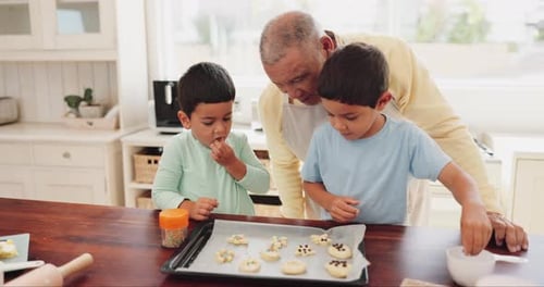 Grandfather and Grandchildren Baking Cookies in Home Kitchen