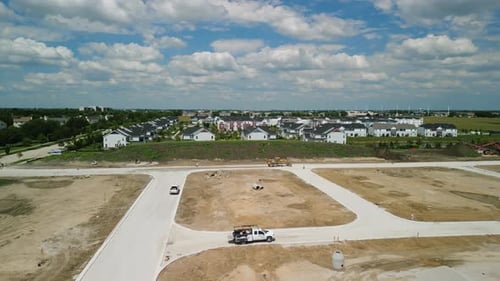 Aerial of Suburb in Pre Construction Empty Lots and Home