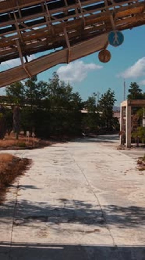 Desolate Abandoned Industrial Factory Decaying Under Sunny Blue Sky