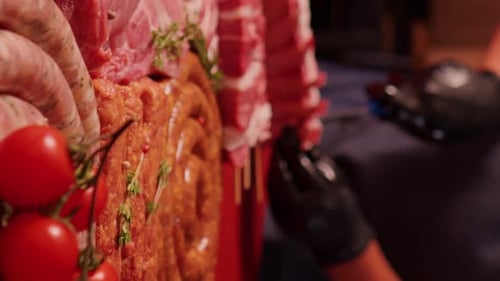 Vertical Screen Close-up raw chopped lamb ribs on red cutting board.