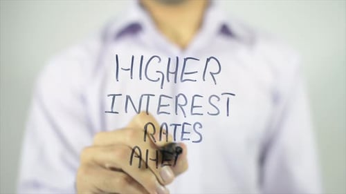 Hand Writing Higher Interest Rates Ahead on Glass