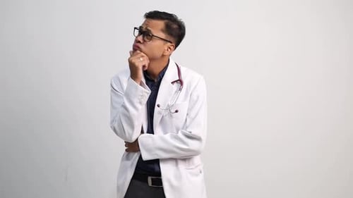 Pensive young man in white doctor lab coat