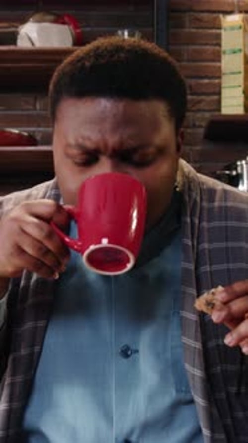 Person Eating Cookies in Pajamas and Drinking