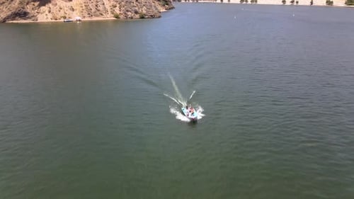 Flying on a drone, the view of the boats in motion in a lake in California