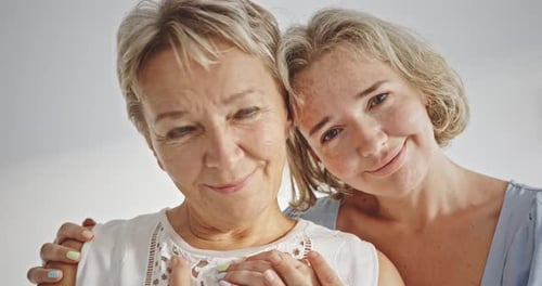 Senior and Adult Woman Embracing Lovingly