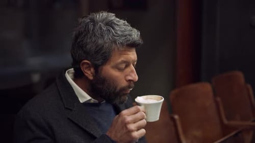 Italian man spits out disgusting coffee outside a cafe in Italy