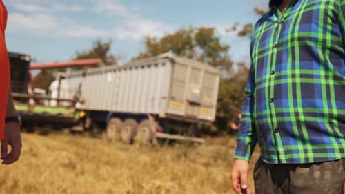 Farmer and Agronomist Shaking Hands Standing in a Wheat Field After Agreement Agriculture Business