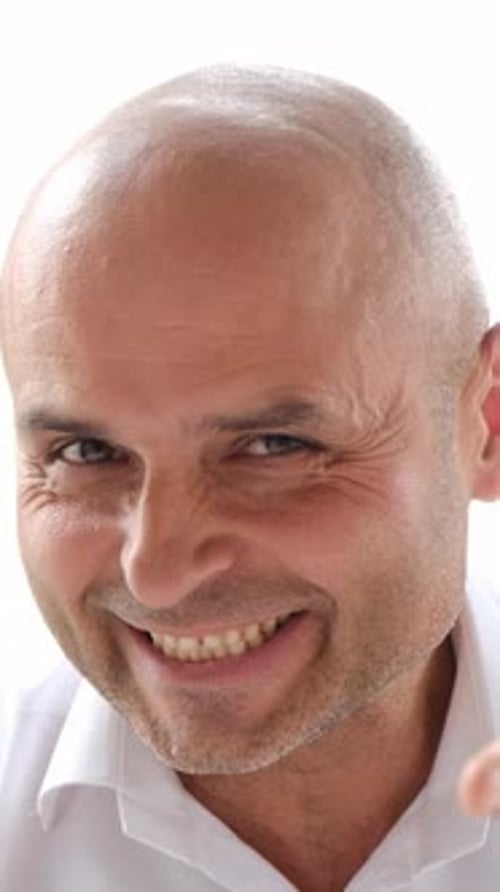 Adult Man Smiles and Speaks Into Camera
