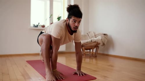 Man Doing Yoga Exercise Indoors on Yoga Mat