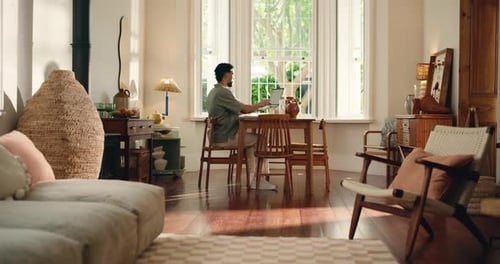 Man Working on Laptop at Home During Daytime