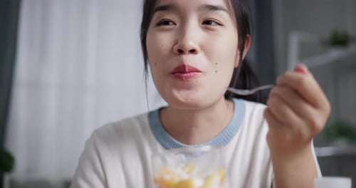 Woman Eating Fruit and Cream Dessert Close Up