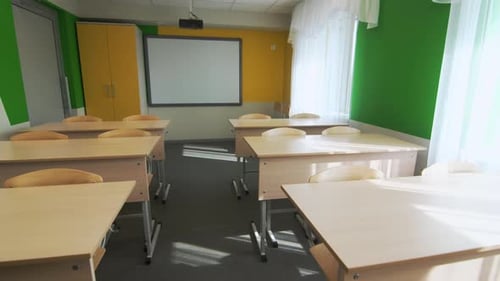 Bright Empty Classroom with Desks and Whiteboard