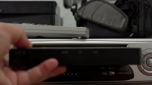 A video cassette is inserted into the Silver VCR.