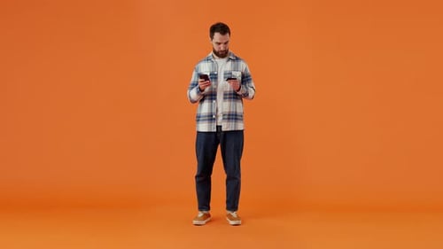 Caucasian Man Using Modern Smartphone and Credit Card at Studio