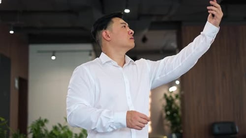 Man Gesturing While Using Smartphone