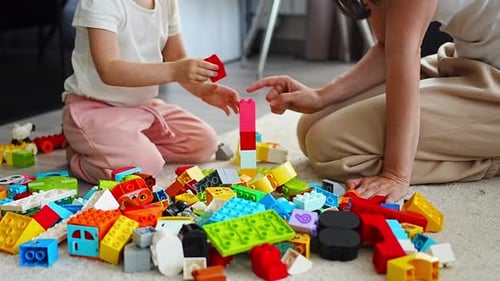 Child and Adult Building Block Tower Together