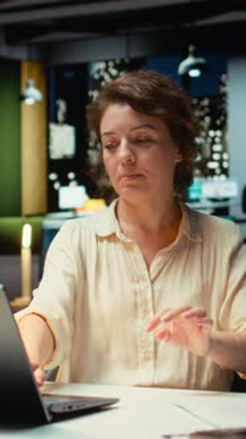Woman Relaxing After Working on Laptop at Desk