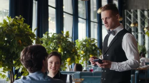 Waiter Talking to Couple Placing Order in Fine Dining Restaurant