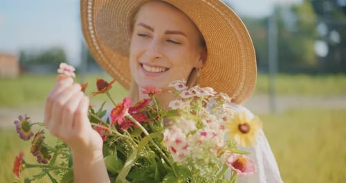 Dreamy Woman Smiling Holding Flowers