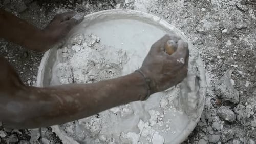 Mixing Plaster Material in White Container