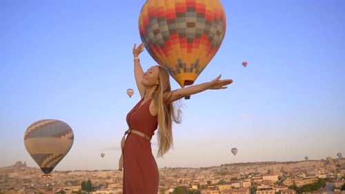 Happy Woman Looking at Hot Air Balloons in Cappadocia Turkey Happy Travel in Turkey Concept Woman on