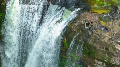 A waterfall in a beautiful tropical forest. Drone view.