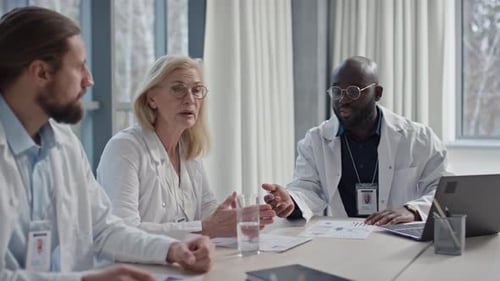 Hospital Workers Discussing Issues at Boardroom