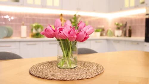 Bright Pink Tulips on Wooden Table in Kitchen