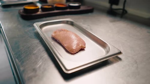 Raw Duck Meat on Metal Tray in Kitchen