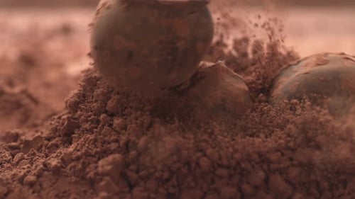 Truffle Chocolate Balls Falling into Cocoa Powder