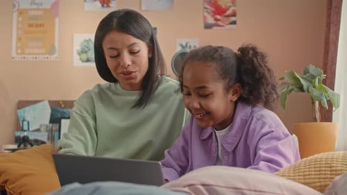Woman and Child Using Laptop Together