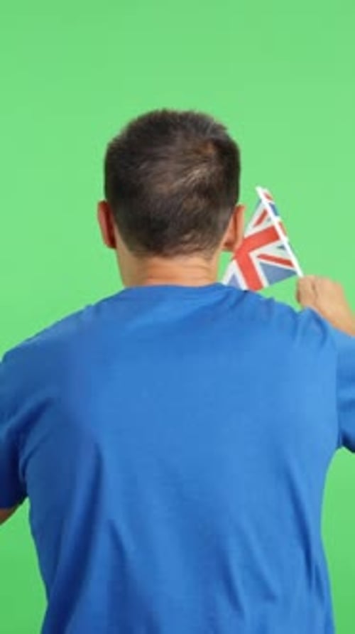 Rear View of a Man Waving a British Pennant