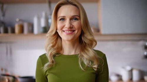 Smiling Woman with Salad in Bright Kitchen