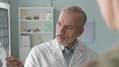 Doctor Explains Brain Scan Results to Patient
