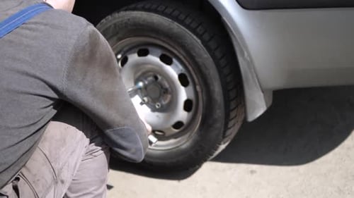 Car wheel service. Mechanic changing tires and rims, balancing the wheels
