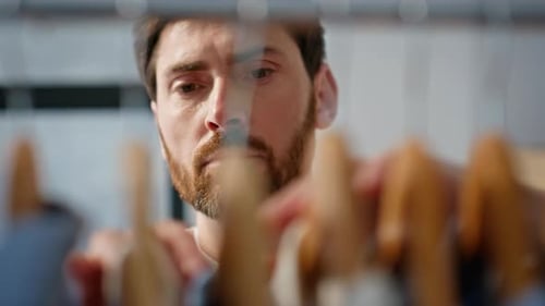 Man Selecting Shirt in Bedroom Wardrobe